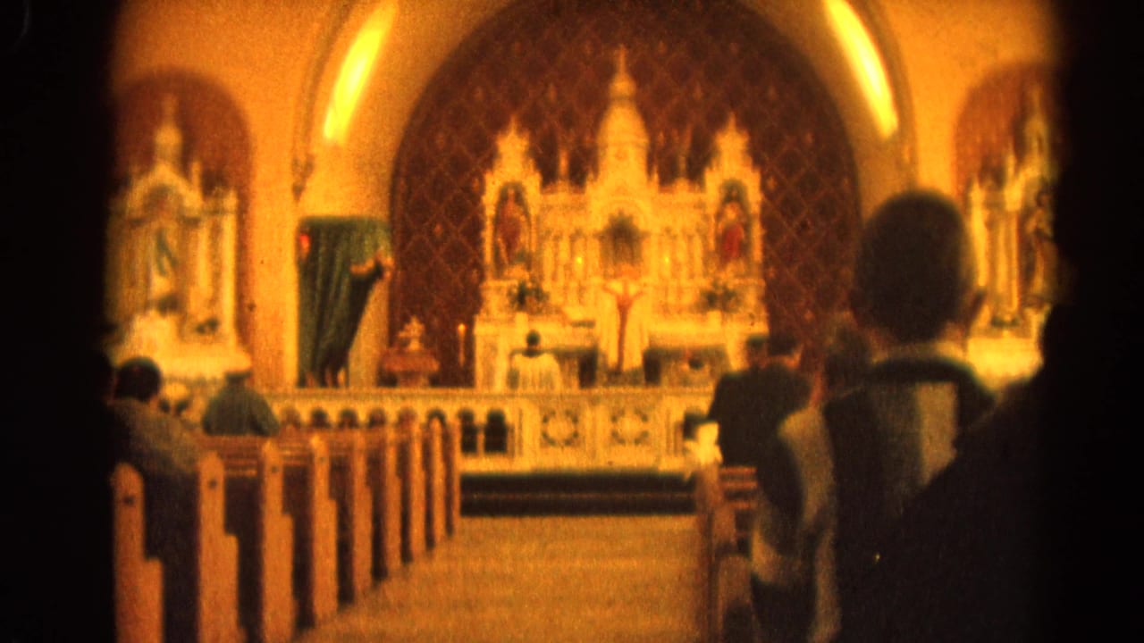 Church aisle and pews lead toward an altar with religious figures.