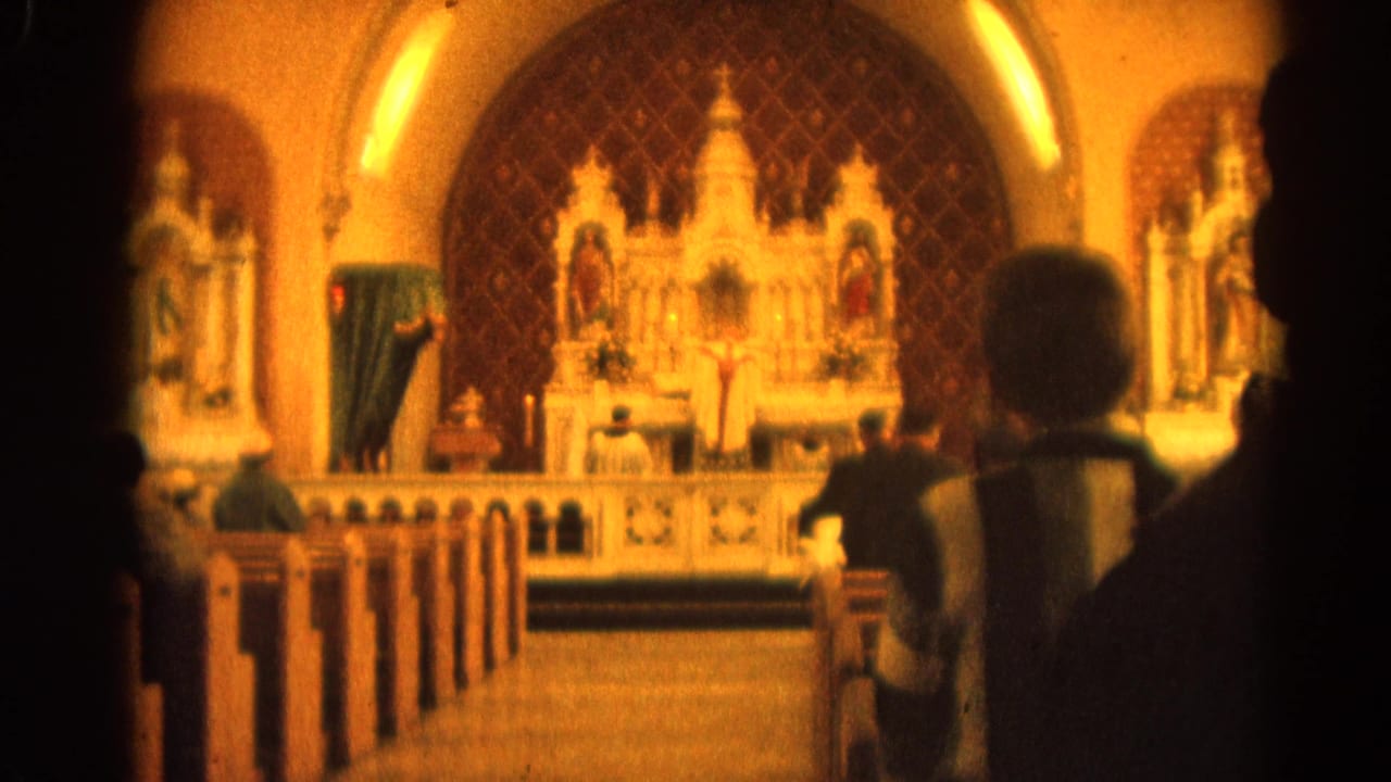 1964 Harvard, Illinois 8mm view from the nave toward an ornate Catholic altar with clergy and silhouetted parishioners.
