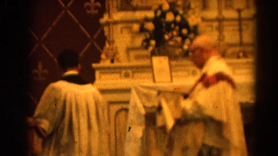 Home-movie view of Catholic clergy and an altar server moving beside the altar in Harvard, Illinois, in 1964.