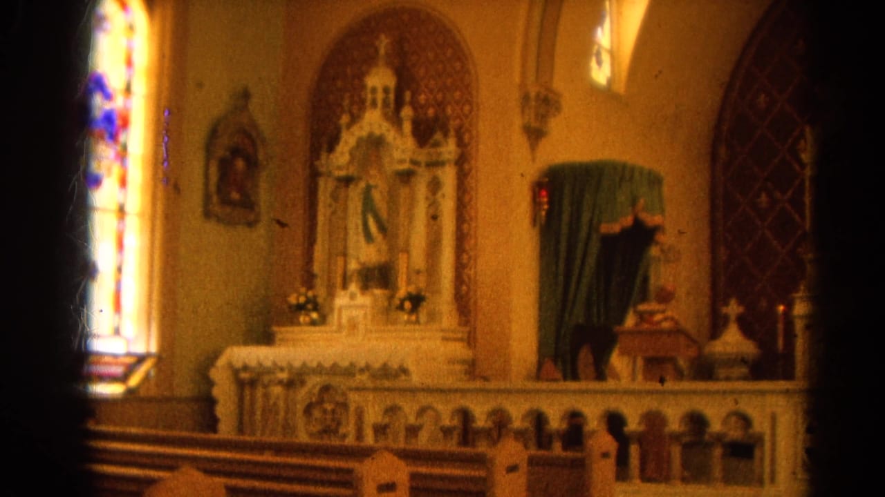 Catholic altar with stained glass, religious statuary, pews, and dark film-edge shadow.