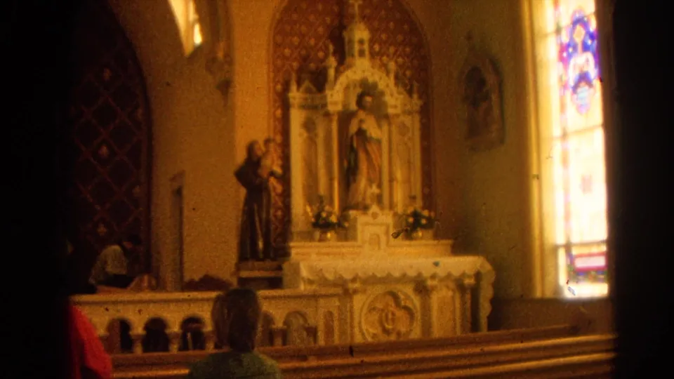 1964 Harvard, Illinois church interior showing an ornate altar, religious statuary, stained glass, pews, and parishioners viewed from behind.