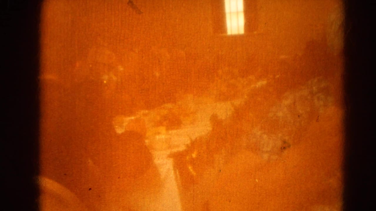 Warm orange film flare or obstructed frame with a faint interior reflection.