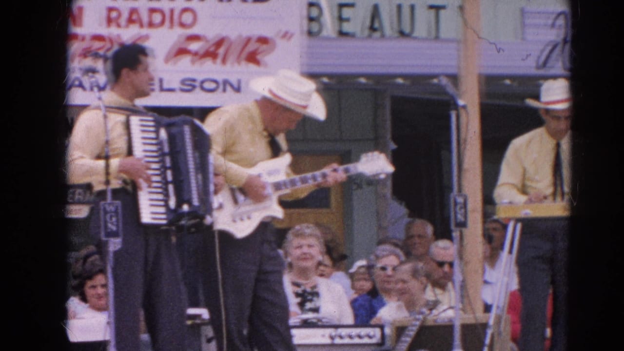 Accordionist and guitarist stand near microphones while a keyboard player appears at the side of the stage.