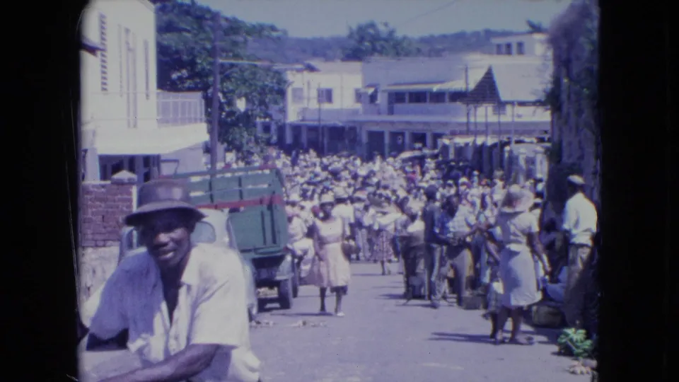 At the end of the clip, the loaded-bicycle rider is close to the camera while the Kingston street crowd continues in the background.