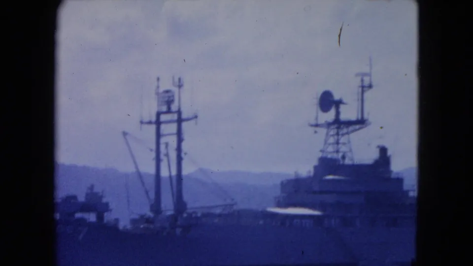Vintage 8mm frame showing naval ship mast and radar-like equipment offshore near Montego Bay.