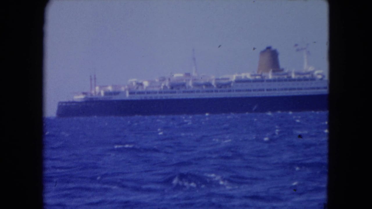 Passenger ship viewed from a distance across the sea.