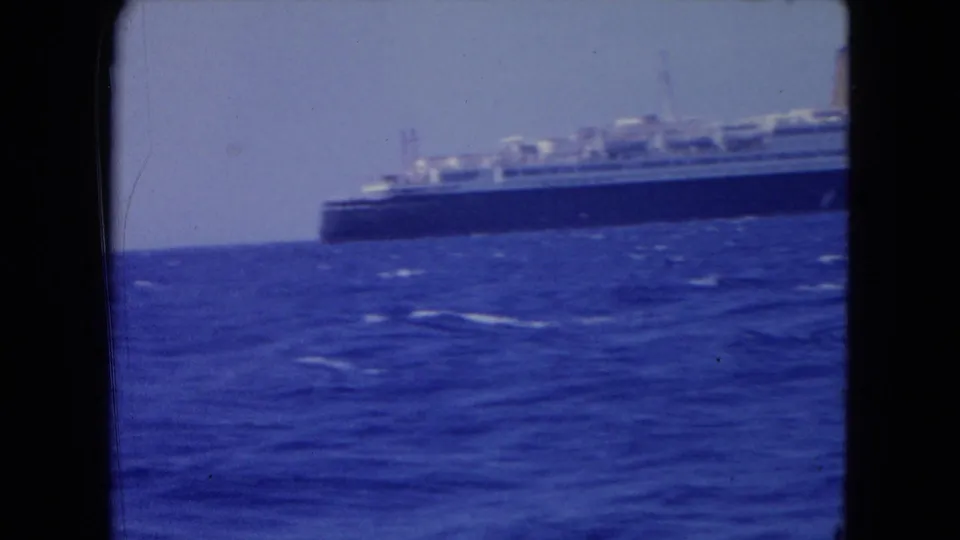 Distant ocean liner on blue water, softly focused in 1964 home-movie footage from Montego Bay.