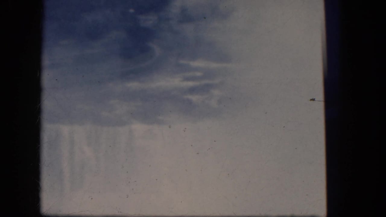 Faded 8mm frame of water and mist over the waterfall edge.