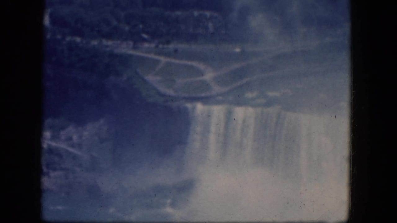 Soft blue view of Niagara Falls and mist from an elevated overlook.
