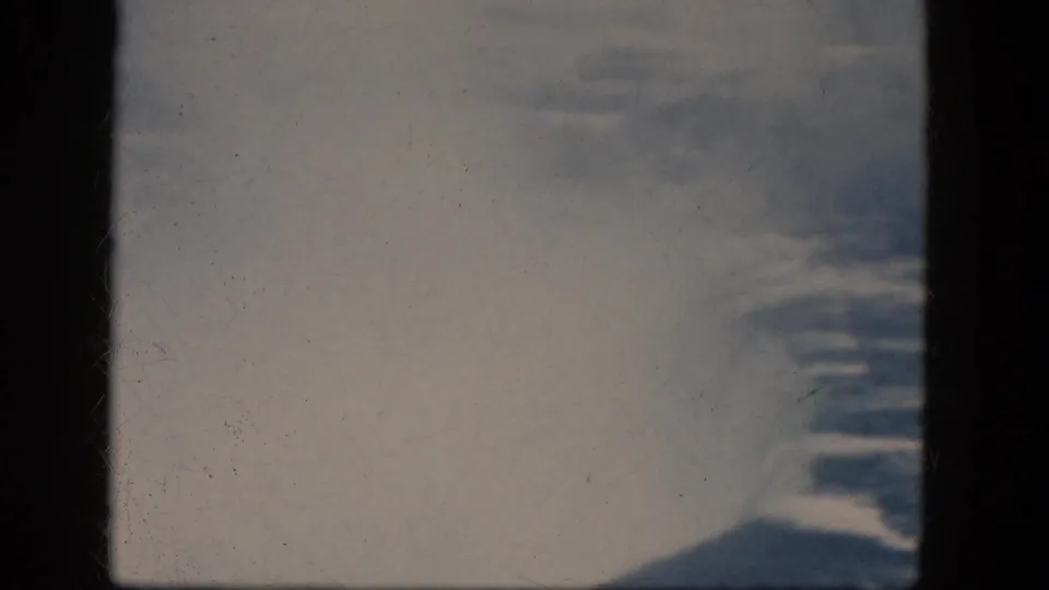 Overexposed 1964 8mm view of Niagara Falls water and mist, with river texture and dark film borders visible.