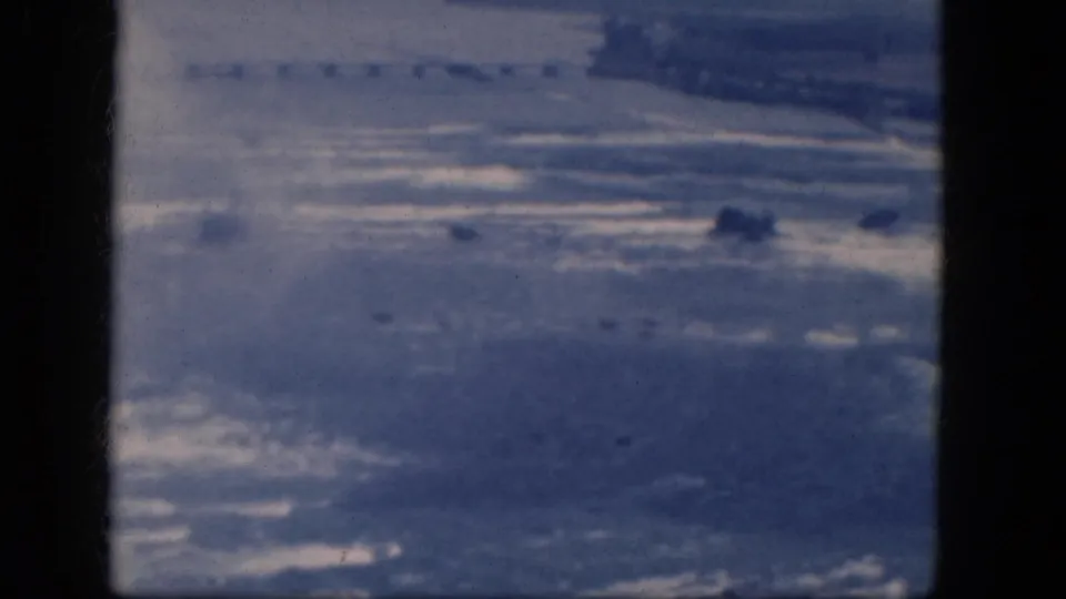 1964 Niagara Falls, Canada frame showing a soft, blue-toned water surface with faint rocks and 8mm border artifacts.