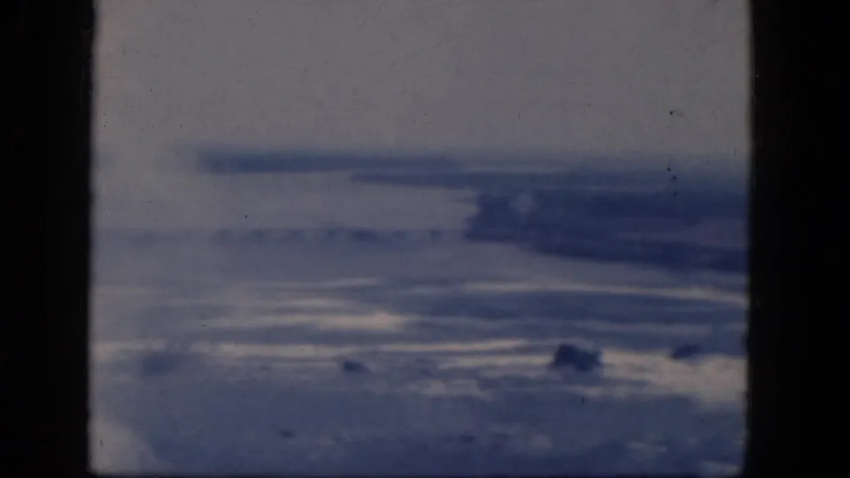 1964 8mm-style airplane-window view over a hazy landscape associated with Niagara Falls, Canada metadata.