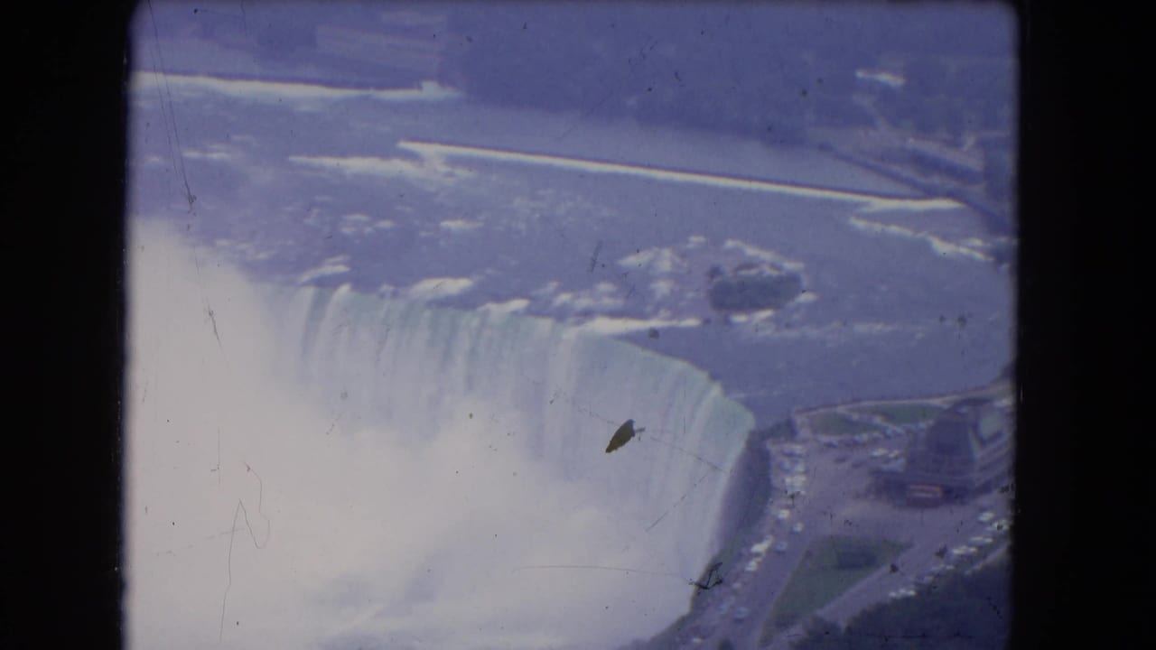 Aerial view of Horseshoe Falls with mist rising and roads near the riverbank.