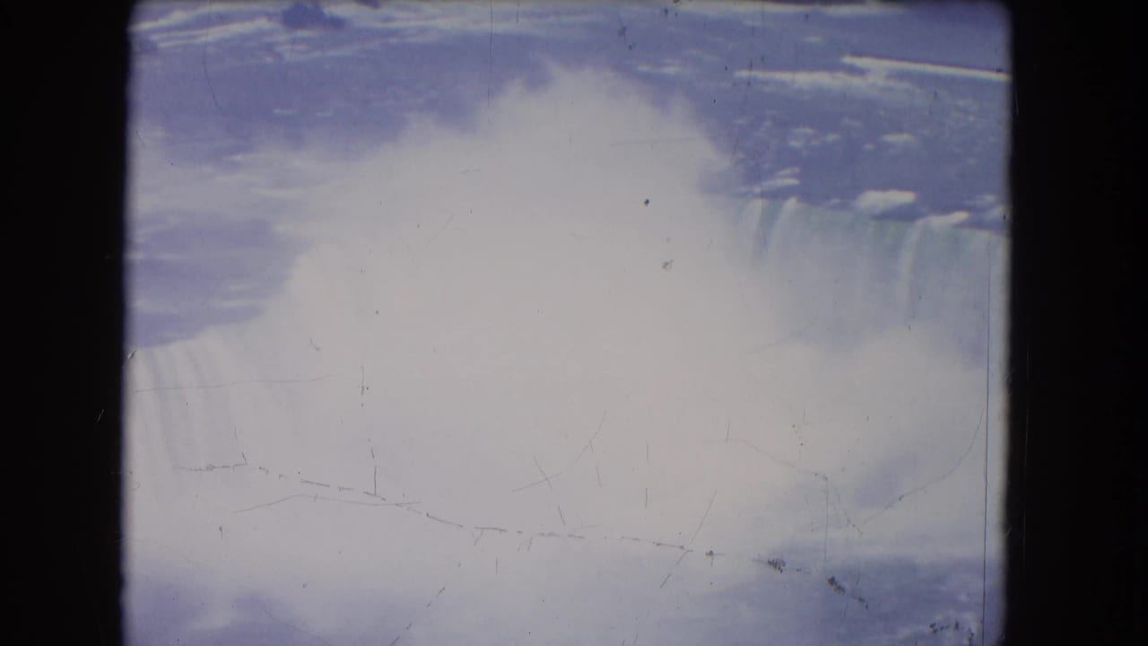 Misty waterfall seen from above with dark 8mm frame borders.