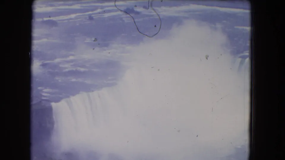 Niagara Falls in 1964 home-movie footage, with mist blooming over the cascade and visible film wear.