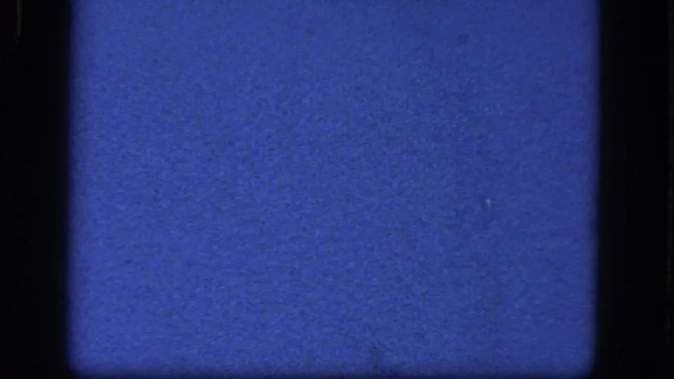 1964 Niagara Falls reel frame showing a blue 8mm film surface with dark side borders, fine grain, and small dust marks.