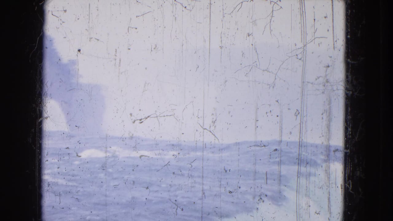 Wide pale view of falls mist and moving water with heavy film scratches.