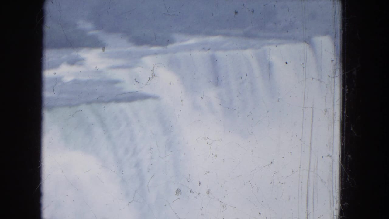 1964 8mm close view of the waterfall curtain at Niagara Falls, softened by mist and film grain.