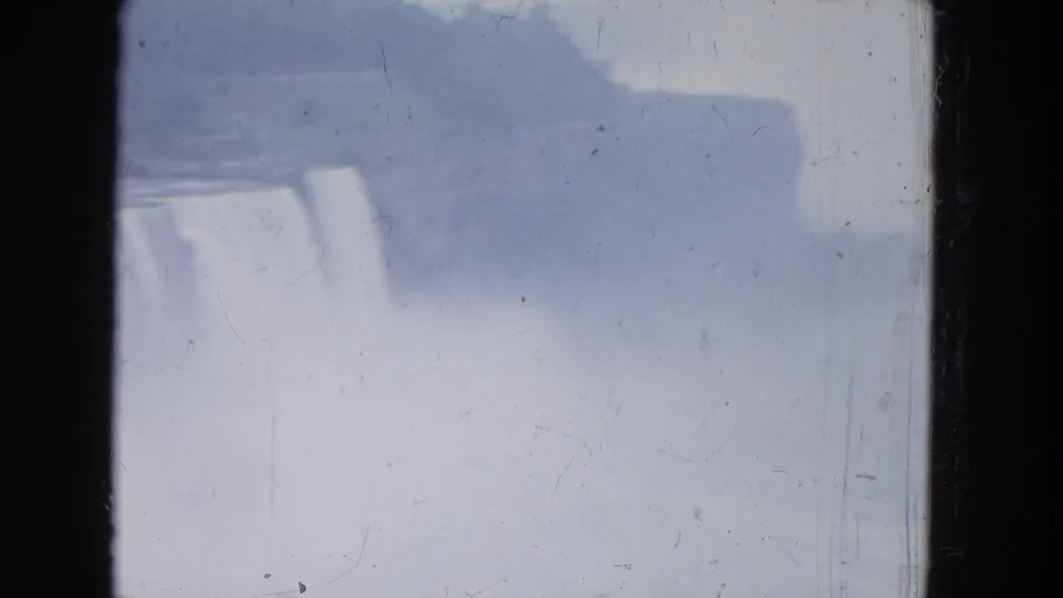 1964 8mm view of Niagara Falls fading into mist, with the cascade partly obscured by spray and exposure haze.