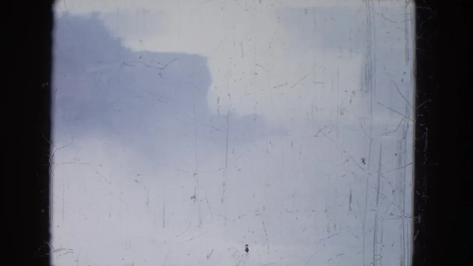 1964 8mm Niagara Falls footage showing pale storm clouds, mist, scratches, and dark frame borders.
