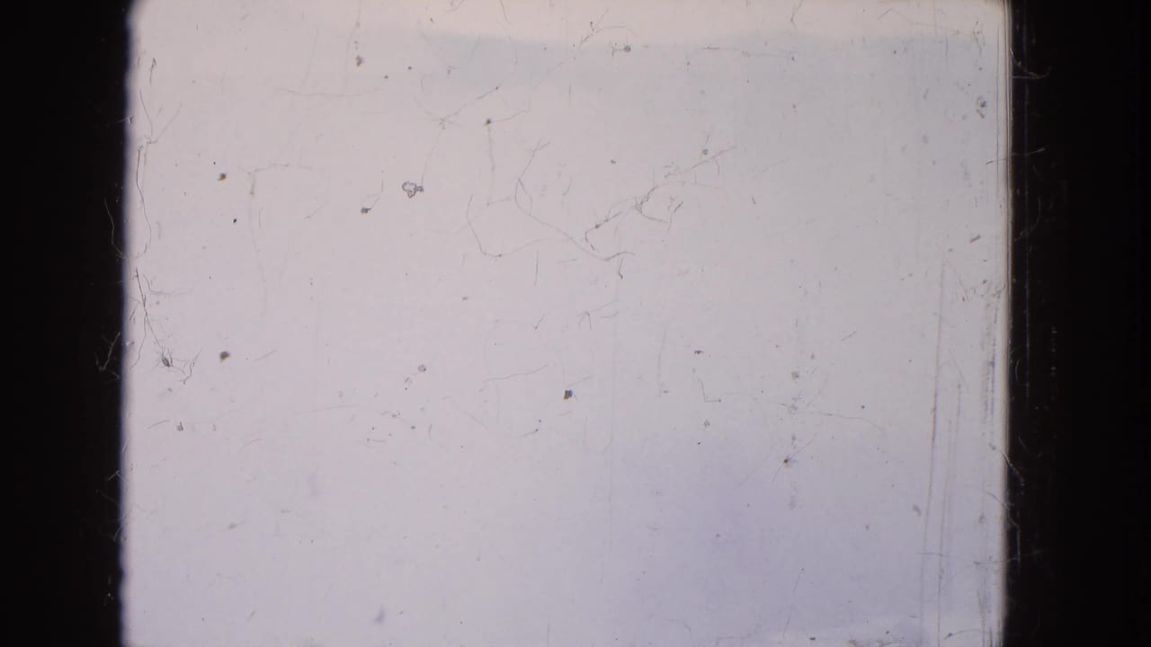 1964 Niagara Falls 8mm frame showing a nearly blank foggy winter view through a boat window, with dark mullions and surface scratches.