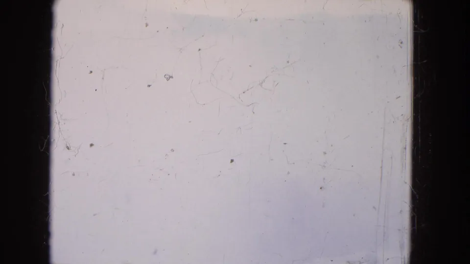 1964 Niagara Falls 8mm frame showing a nearly blank foggy winter view through a boat window, with dark mullions and surface scratches.