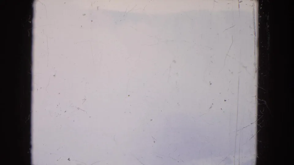 Overexposed or blank 8mm frame from the 1964 Niagara Falls reel, with dark film borders, dust, and scratches visible.
