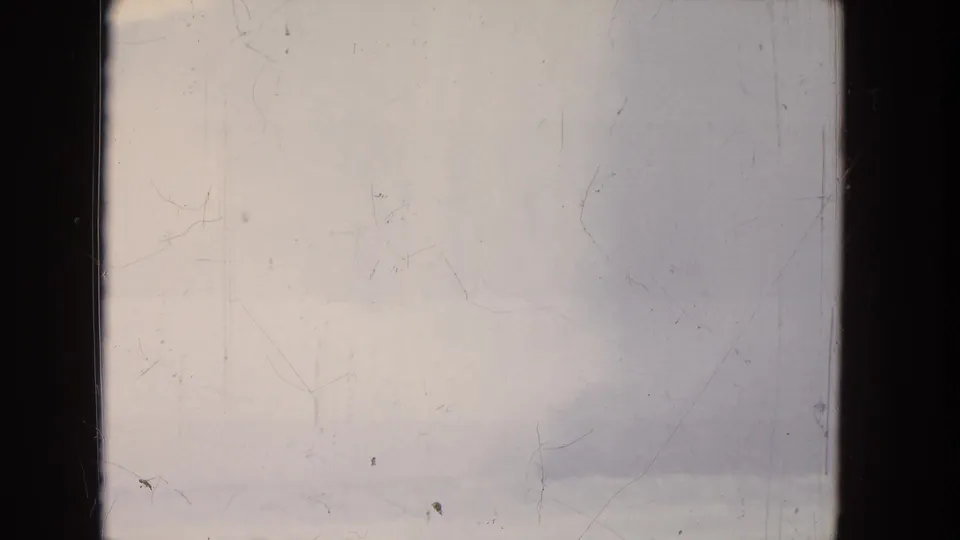 1964 8mm home-movie frame showing a soft, distant Niagara Falls view with mist, pale sky, and visible film scratches.