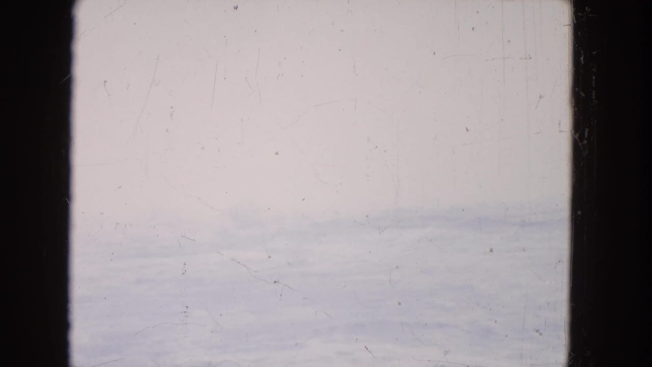 Hazy water surface visible through a dark central divider and side edge.