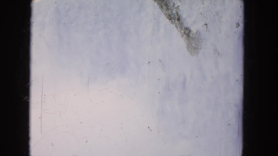 Aged 8mm frame from a 1964 Niagara Falls boat ride, showing pale moving water, dark borders, and visible scratches.