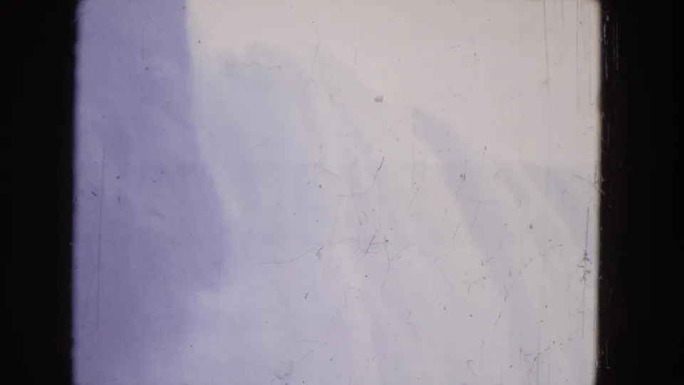 1964 Niagara Falls 8mm frame with bright mist, pale cascading water, purple color shift, and visible dust marks.