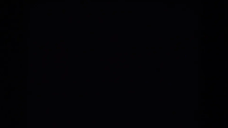 1964 8mm home-movie frame from a Niagara Falls reel showing near-total darkness with a dim lower strip of film texture.