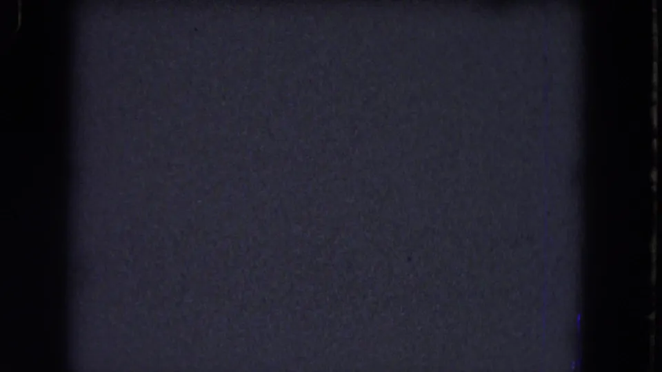 Blue-gray underexposed 8mm frame from the 1964 Niagara Falls reel, bordered by dark gate edges and visible film grain.