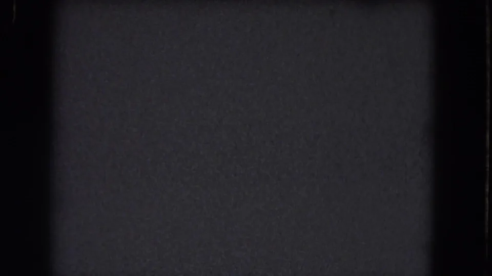 1964 8mm frame from the Niagara Falls clip showing a dark static-like screen texture with black borders and faint grain.