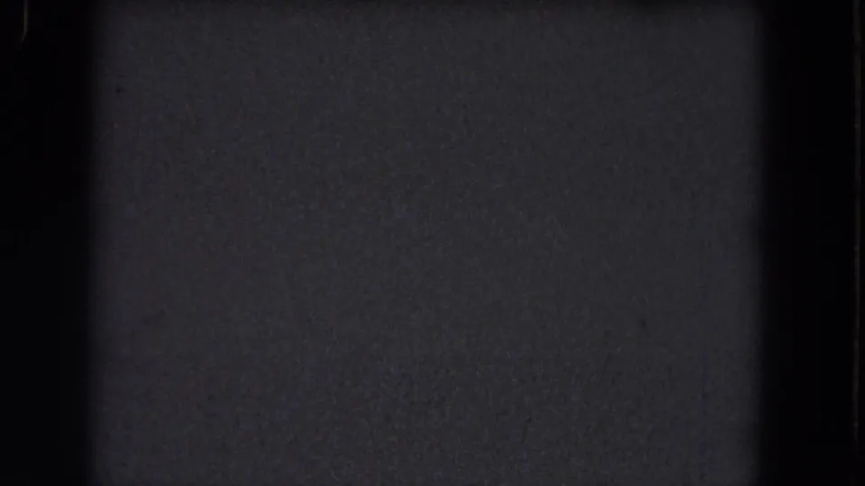1964 8mm Niagara Falls frame showing a nearly blank dark screen with subtle grain, a black divider, and no identifiable subject.