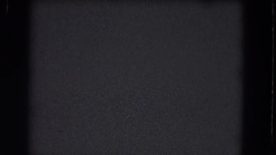 Dark 8mm home-movie frame from the 1964 Niagara Falls reel, showing grain, a black border, and a contact-sheet seam.