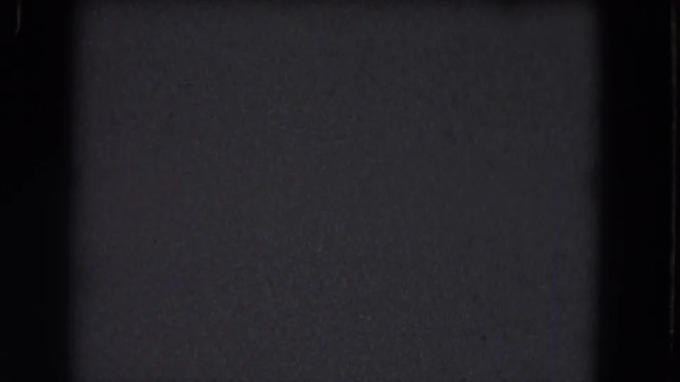Blank-looking 1964 8mm frame from the Niagara Falls reel, with dense grain, dark exposure, and visible frame edge.