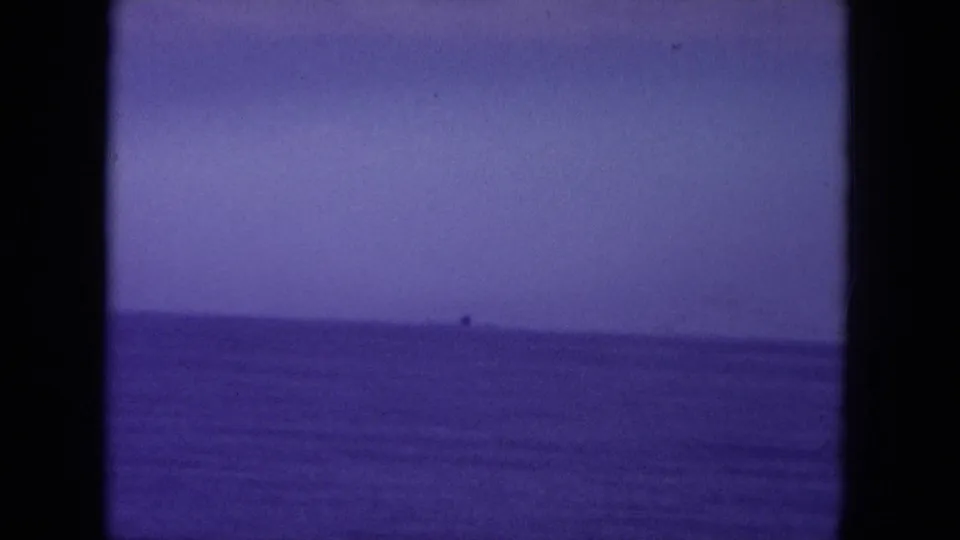 Purple-shifted 8mm view of open water near Oahi, Hawaii, with a level horizon and black frame edges.