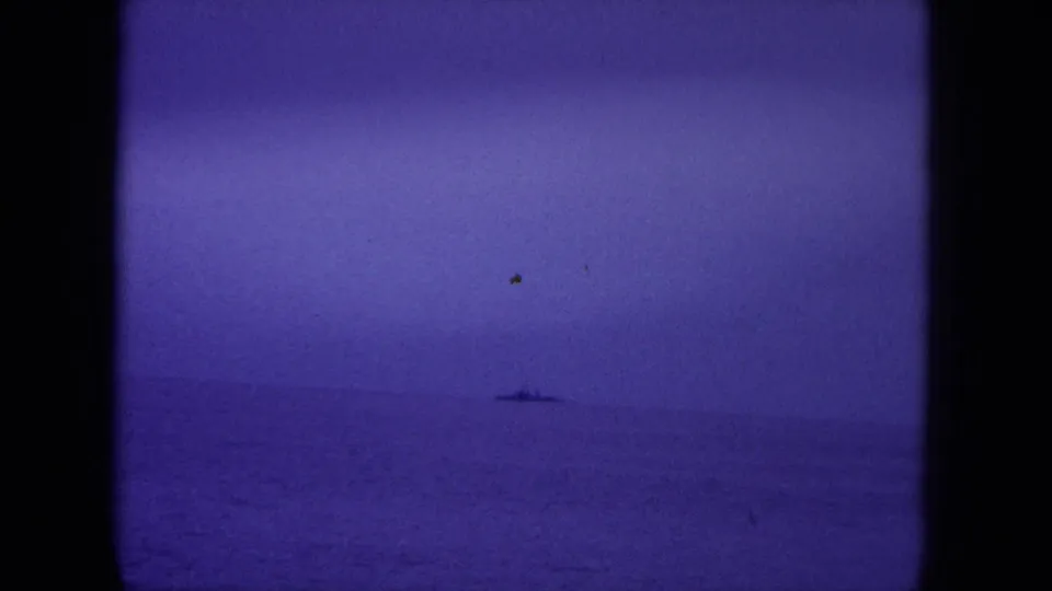 1964 8mm Hawaii sea frame with a small ship silhouette below a pale purple dawn sky.