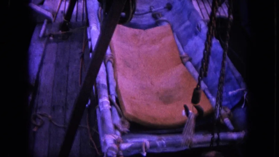 Close 1964 Hawaii home-movie view of boat fittings, ropes, and a seat or panel as the action continues nearby.