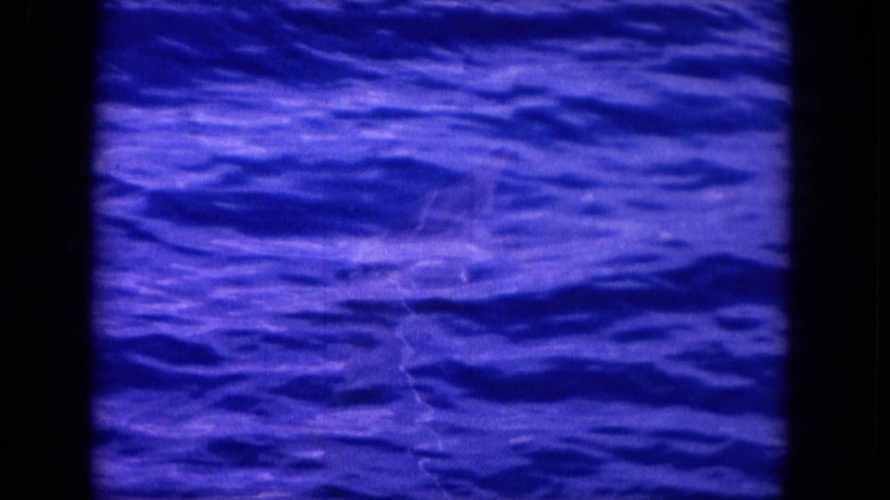 Blue ocean surface with faint movement under the water and dark 8mm frame edges.