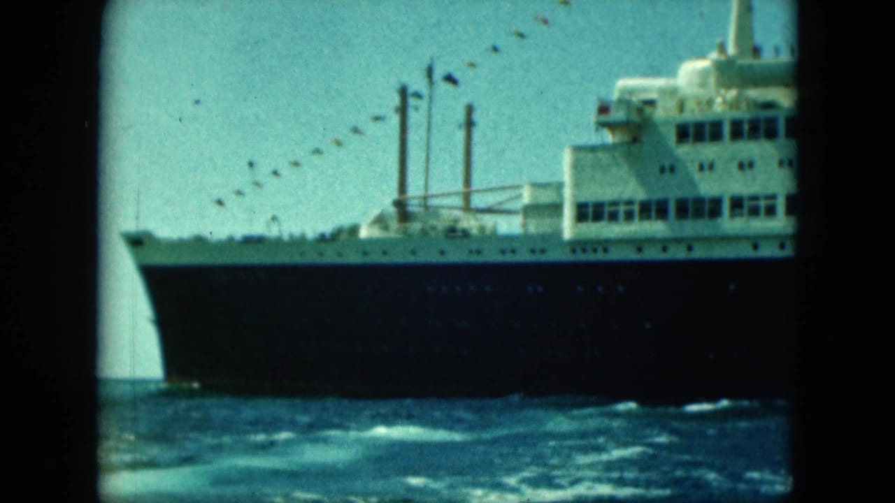 Large ocean liner with a dark hull and white upper decks on blue water.