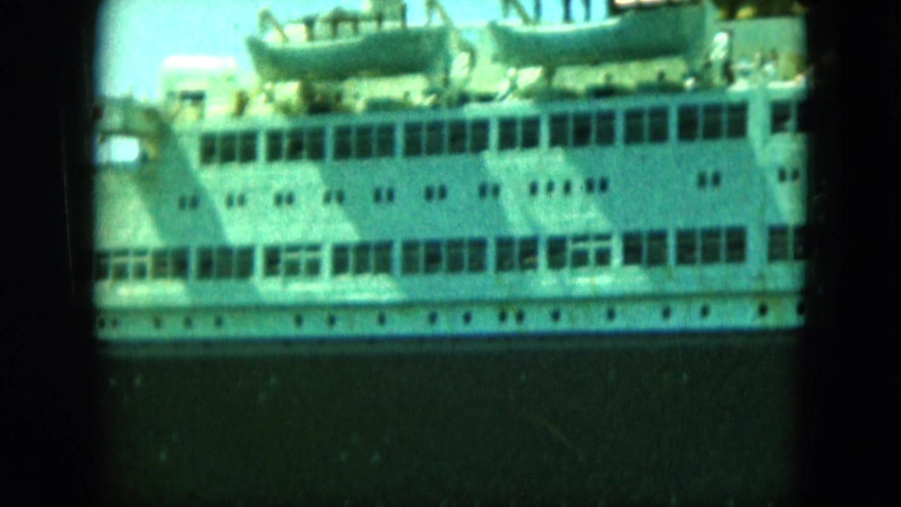 White passenger ship side with rows of windows and lifeboats above a dark hull.