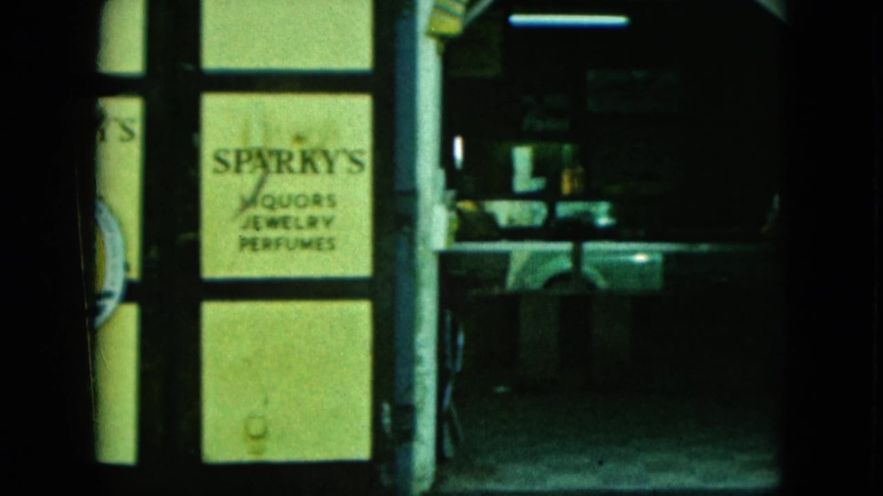 Second view of Sparky's glass storefront beside a dark interior opening.