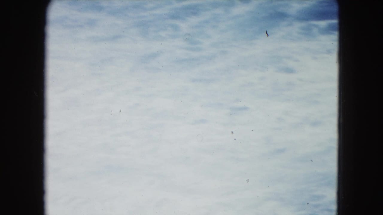 Soft blue ocean surface seen through a dark 8mm frame border.