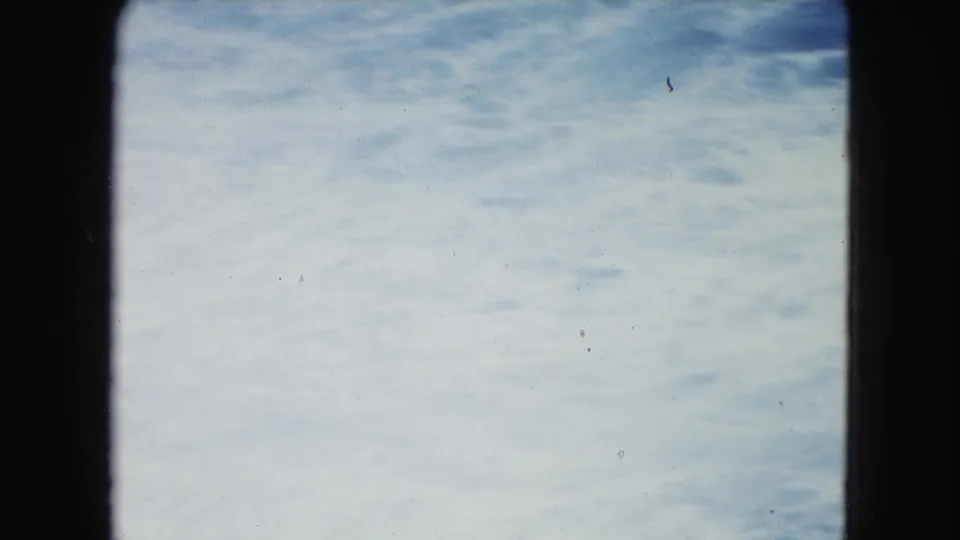 1964 8mm home-movie frame from San Juan, Puerto Rico, showing pale blue ocean water within dark film-frame edges.