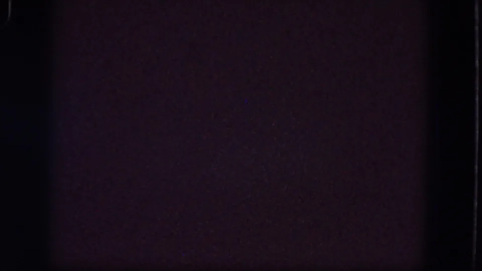 Dark 1964 8mm home-movie frame from Troy, New York with muted purple-brown grain and faint film-edge artifacts.