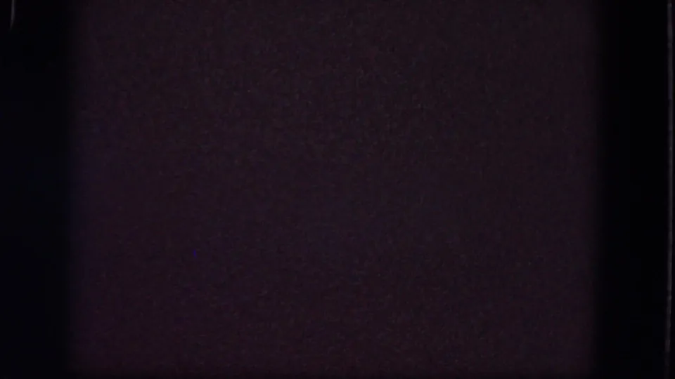 1964 8mm frame from supplied Troy reel metadata showing a blank, grainy field with dark borders and subdued color shift.