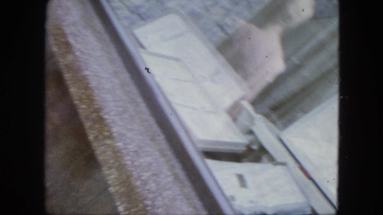 Soft, abstract close view of a pale shop window or reflective surface beside a dark film border.