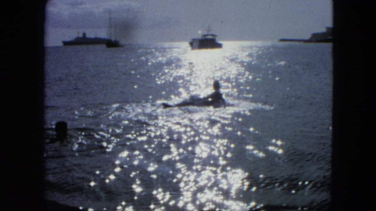Sunlit harbor water with a swimmer or low boat silhouette and distant vessels.